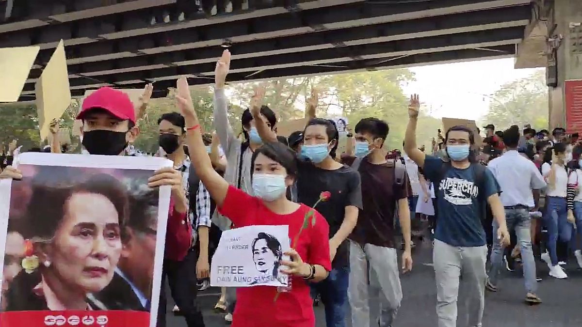 In this image provided by the Democratic Voice of Burma (DVB), protesters in Yangon hold images of deposed Myanmar leader Aung San Suu Kyi, Sunday, February 7, 2021.