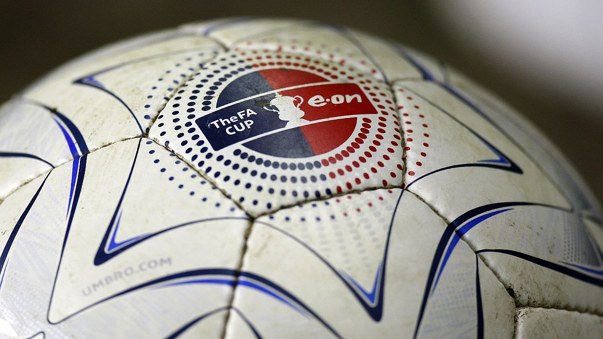 A football with an FA Cup logo sits on the sideline