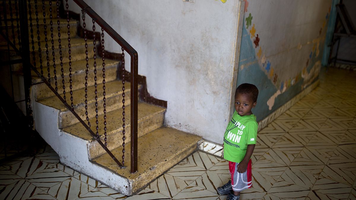 In this June 28, 2018 photo, a boy stands next to a staircase while looking out from the Nest of Hope orphanage in Port-au-Prince, Haiti. 