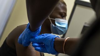 Thabisle Khlatshwayo receives her second AstraZeneca shot at a vaccine trial facility set at Soweto's Chris Sani Baragwanath Hospital outside Johannesburg, South Africa. 