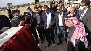 Passengers cross the Rafah border after Egypt re-opens it
