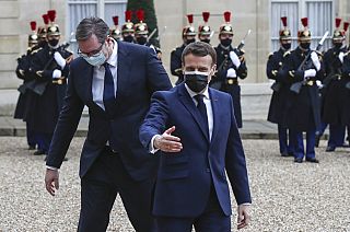 French President Emmanuel Macron, right, welcomes Serbian President Aleksandar Vucic for a working lunch at the Elysee Palace in Paris, Monday, Feb. 1, 2021.