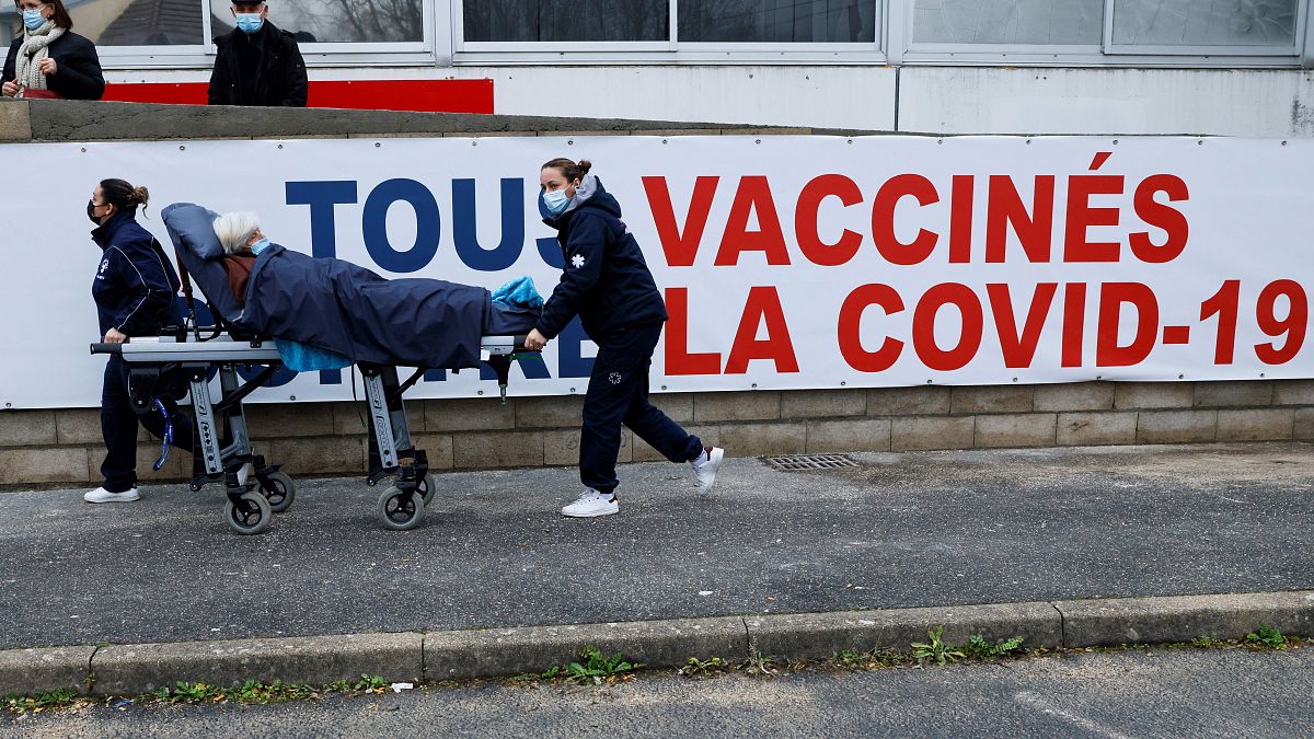 A woman is carried on a stretcher to the Covid-19 vaccination center of the South Ile-de-France Hospital Group in Melun, in the outskirts of Paris, Feb. 8, 2021.