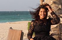 This undated handout picture released on the Facebook page of Saudi activist Loujain al-Hathloul shows her posing for a picture in a dress by a beach.