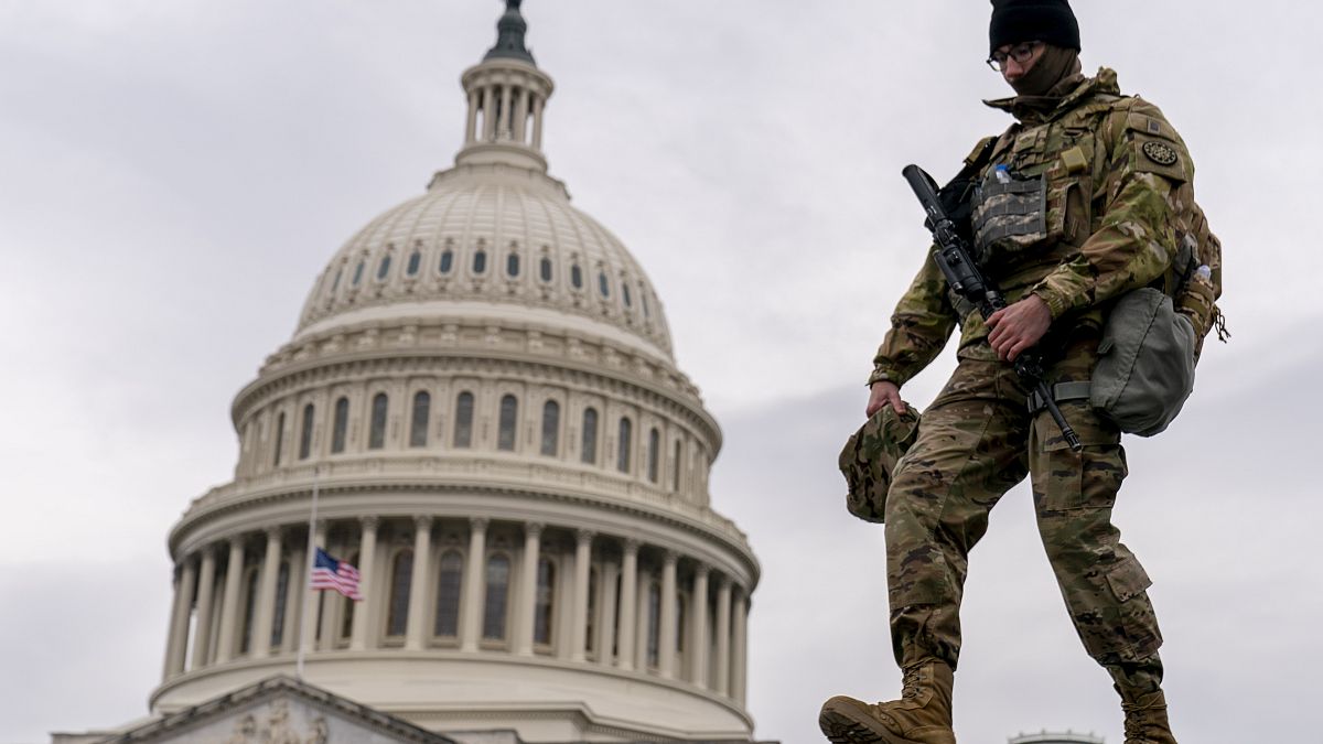 A member of the National Guard walks past the U.S. Capitol during the second impeachment trial of former President Donald Trump in Washington, Wednesday, Feb. 10, 2021.