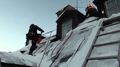  Roofer clearing snow