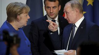 German Chancellor Angela Merkel, French President Emmanuel Macron and Russian President Vladimir Putin 