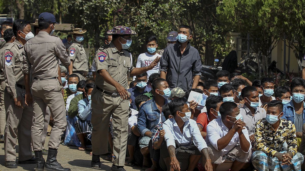 Prisoners, soon to be released marking the 74th anniversary of Myanmar's Union Day, wait for processing at the Insein prison in Yangon, Myanmar Friday, Feb. 12, 2021.