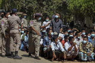 Prisoners, soon to be released marking the 74th anniversary of Myanmar's Union Day, wait for processing at the Insein prison in Yangon, Myanmar Friday, Feb. 12, 2021.