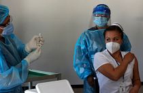Nurse Cristina Chango receives her first dose of the Pfizer-BioNtech vaccine against COVID-19 at the Pablo Arturo Suarez Hospital in Quito, Ecuador, Thursday, Jan. 21, 2021. 