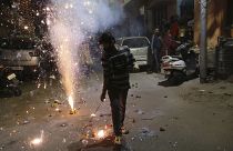 A boy plays with fireworks during Diwali, the Hindu festival of lights, in Jammu, India Saturday, Nov. 14, 2020.