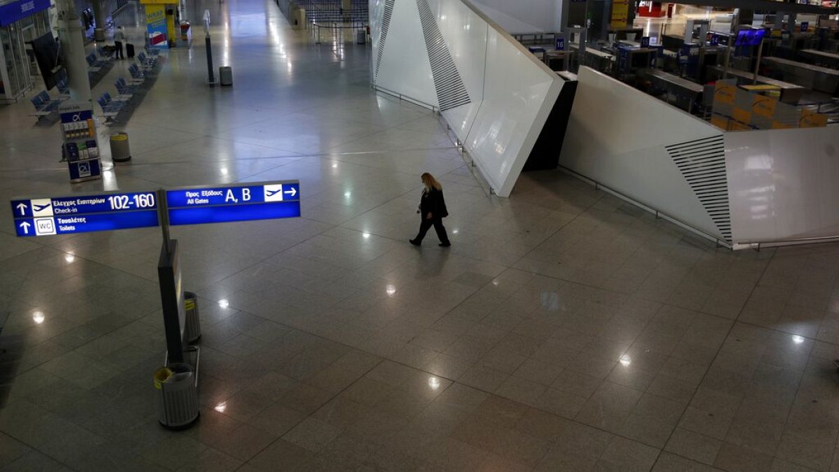 A security walks at the empty Eleftherios Venizelos International Airport