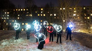 People draw hearts with their cellphones flashlights in support of jailed opposition leader Alexei Navalny and his wife Yulia Navalnaya Moscow, Russia, Sunday, Feb. 14, 2021. 