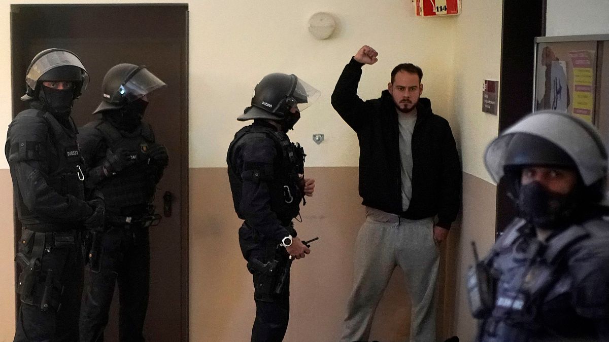 Rap singer Pablo Hasél is detained by police officers at the University of Lleida, Spain, Tuesday, Feb. 16, 2021.