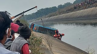 A bus that fell into a canal is pulled out in Sidhi district, in the central Indian state of Madhya Pradesh, Tuesday, Feb. 16, 2021.
