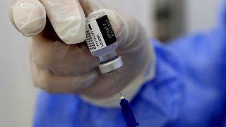 A nurse prepares a syringe of the Pfizer-BioNTech COVID-19 vaccine.