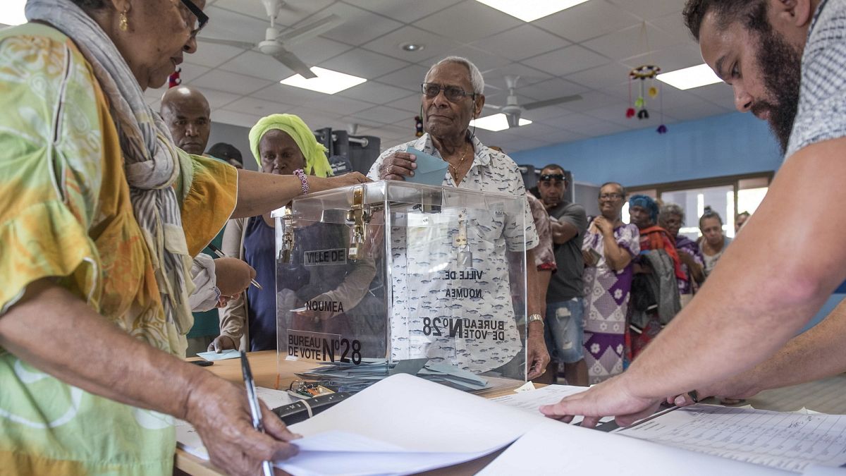 A man casts his vote in Noumea, New Caledonia, Sunday, Oct. 4, 2020, during a referendum whether voters choose independence from France.