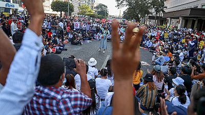 Demonstrators flash the three-fingered salute during a protest against the military coup in Yangon, Myanmar Wednesday, Feb. 17, 2021