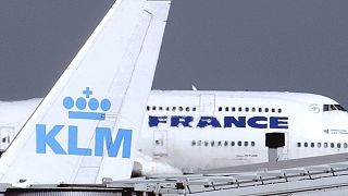 An Air France jumbo jet rolls behind the tail of a KLM Royal Dutch airliner at Charles de Gaulle airport in Roissy, north of Paris. 2003