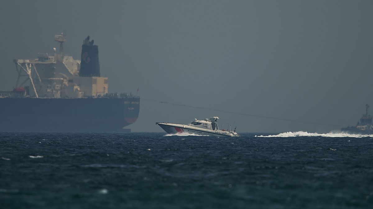 ILLUSTRATION: An Emirati coast guard vessel passes an oil tanker off the coast of Fujairah, United Arab Emirates, May 13, 2019. 