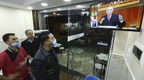 People in a restaurant watch President Abdelmadjid Tebboune's address on Thursday night