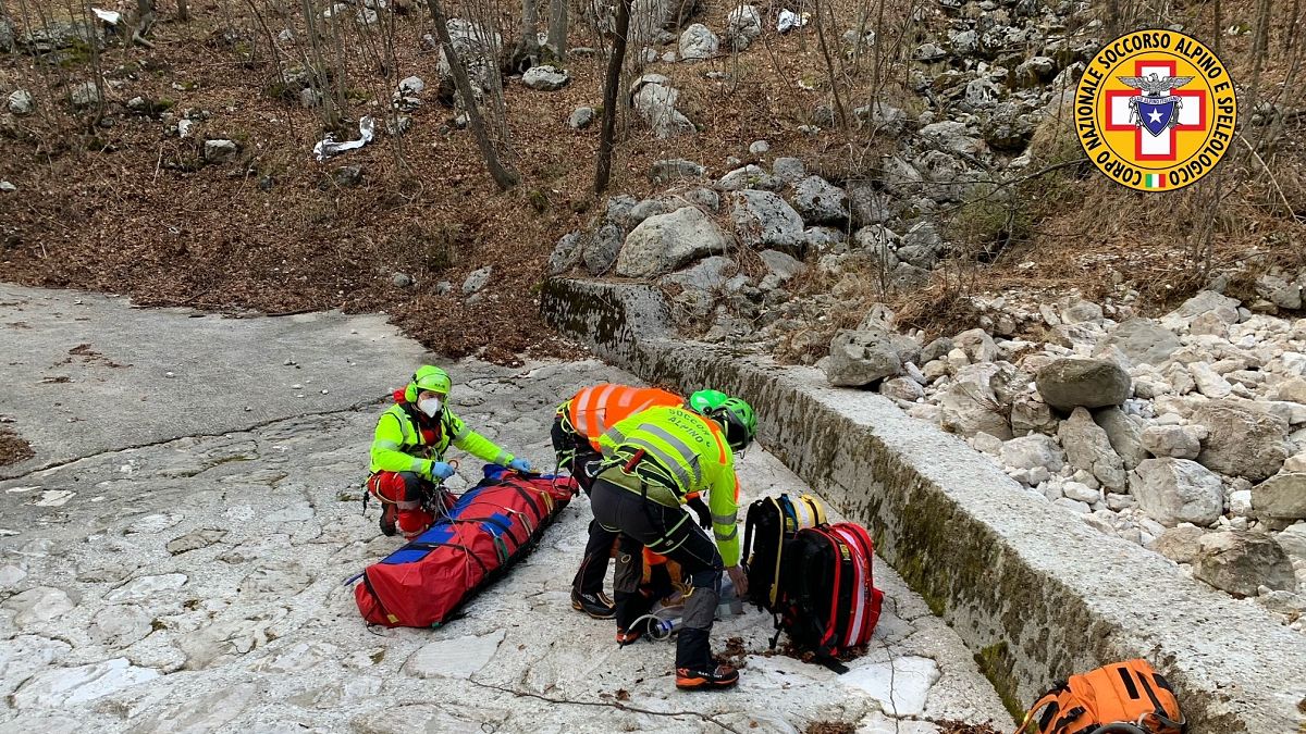 Italy's National Alpine and Speleological Rescue Corps rescue an injured man and his dog on February 18, 2021.