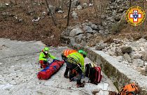 Italy's National Alpine and Speleological Rescue Corps rescue an injured man and his dog on February 18, 2021.