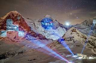A giant projection of the NASA logos on the Bernese Alps mountains by Swiss light artist Gerry Hofstetter. Mannlichen, Switzerland. February 14, 2021