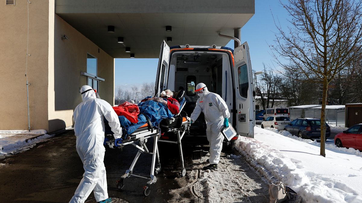 Medical workers move a covid-19 patient into an ambulance at a hospital overrun by the covid pandemic in Cheb, Czech Republic on Feb. 12, 2021.