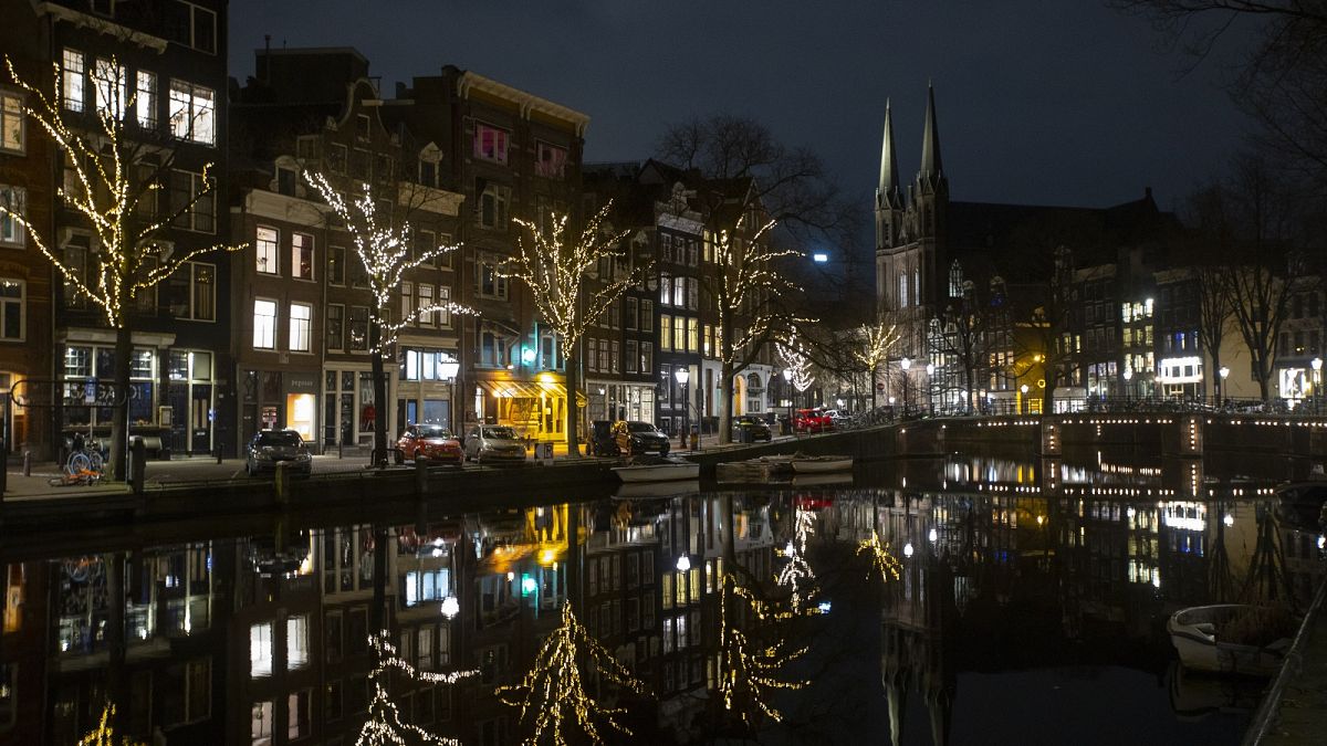 Deserted streets and bridges are seen during curfew in the center of Amsterdam, Saturday, Jan. 23, 2021.