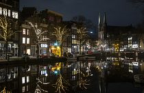 Deserted streets and bridges are seen during curfew in the center of Amsterdam, Saturday, Jan. 23, 2021.