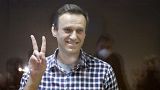Russian opposition leader Alexei Navalny stands in a cage in the Babuskinsky District Court in Moscow, Russia, Saturday, Feb. 20, 2021.