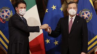 Italian outgoing Premier Giuseppe Conte hands over the cabinet minister bell to new Premier Mario Draghi.