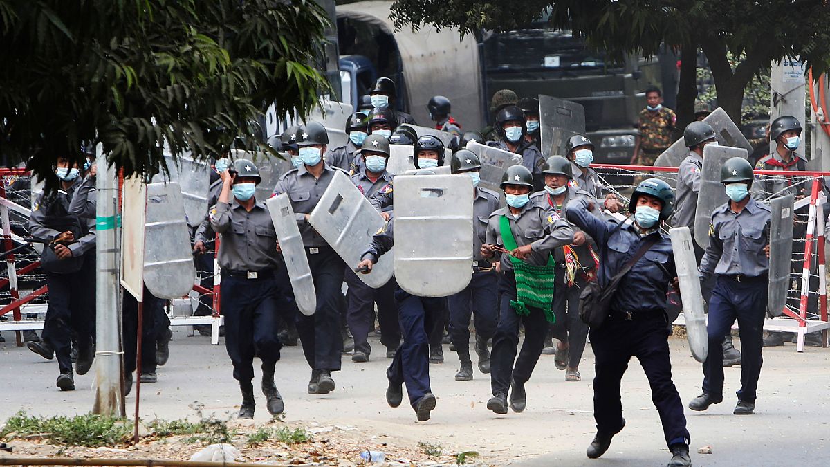 Police charge forward to disperse protesters in Mandalay, Myanmar on Saturday, Feb. 20