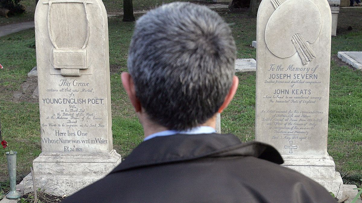 A man stands in front of the graves of English poets Percy Bysshe Shelley and John Keats at a non-Catholic cemetery in Rome, February 2006