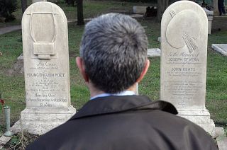 A man stands in front of the graves of English poets Percy Bysshe Shelley and John Keats at a non-Catholic cemetery in Rome, February 2006