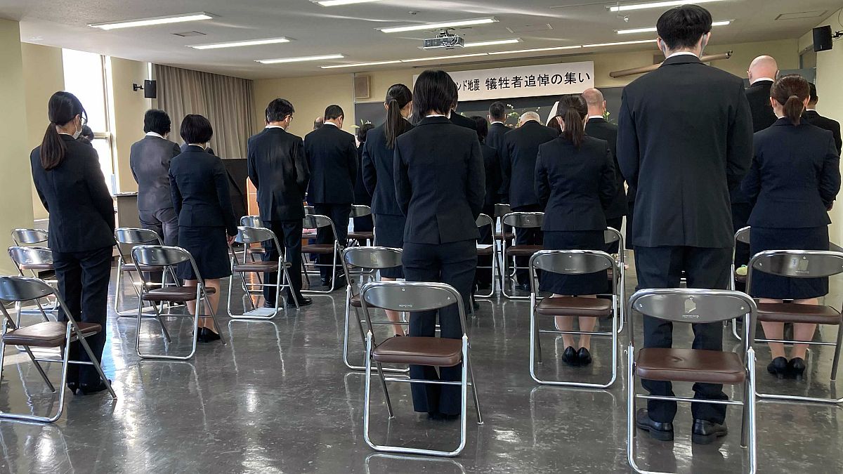Family members and students attend a memorial ceremony at Toyama Foreign Language College to mourn 12 of their students who died during New Zealand's earthquake 10 years  ago.