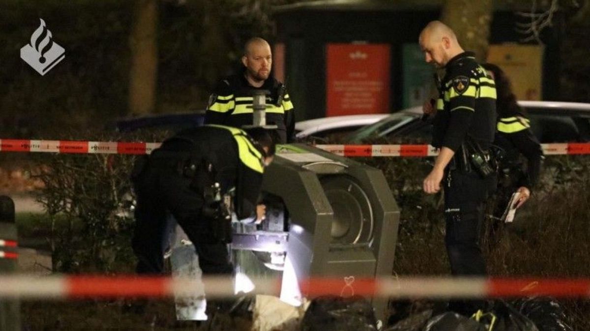 Dutch police inspect the waste container where the baby was found near Amsterdam.