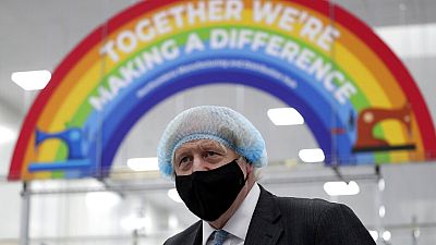 Britain's Prime Minister Boris Johnson, wearing a face mask to prevent the spread of the coronavirus, visits a PPE manufacturing facility in north-east England