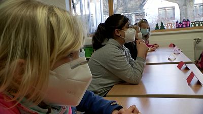 Wearing masks, children returned to primary schools in some parts of Germany on Monday.