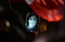 A protester holds up a picture of Daphne Caruana Galizia at a demonstration in Valletta in November 2019.