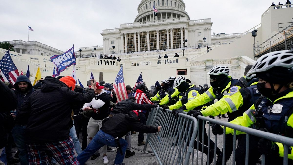 In this Jan. 6, 2021 file photo, rioters try to break through a police barrier at the Capitol in Washington.