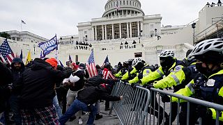 In this Jan. 6, 2021 file photo, rioters try to break through a police barrier at the Capitol in Washington.