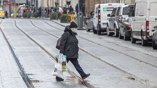 Pedestrians shop in advance of a new coronavirus lockdown in Dublin on December 31, 2020.