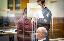 Syrian defendant Eyad Al-Gharib hides his face as he arrives to his hear his verdict in a court room in Koblenz, Germany, Wednesday, Feb. 24, 2021.