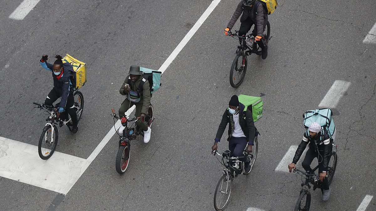 In this Nov. 5, 2020 file photo, food delivery riders stage a protest against the government restriction measures to curb the spread of coronavirus in Milan, Italy.