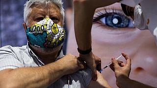 A man receives the second Pfizer-BioNTech COVID-19 vaccine at a vaccination center in Jerusalem, during a nationwide lockdown to curb the spread of the virus