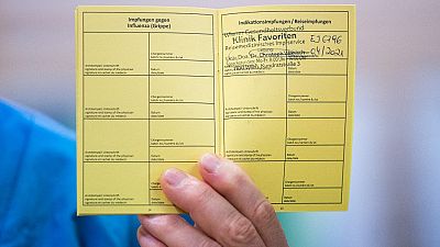 Medical personnel hods a vaccination certificate with a registered Pfizer-Biontech Covid-19 corona virus vaccination at the Favoriten Clinic in Vienna, Austria