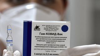 عامل في القطاع الطبي في مونتينيغرو رافعاً اللقاح الروسي سبوتنيك-في