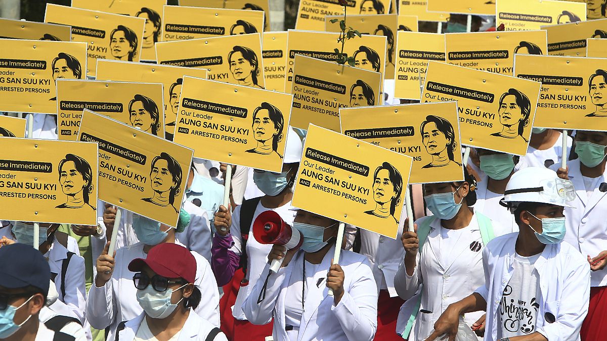Medicals students display images of deposed Myanmar leader Aung San Suu Kyi during a street march in Mandalay, Myanmar, Friday, Feb. 26, 2021.